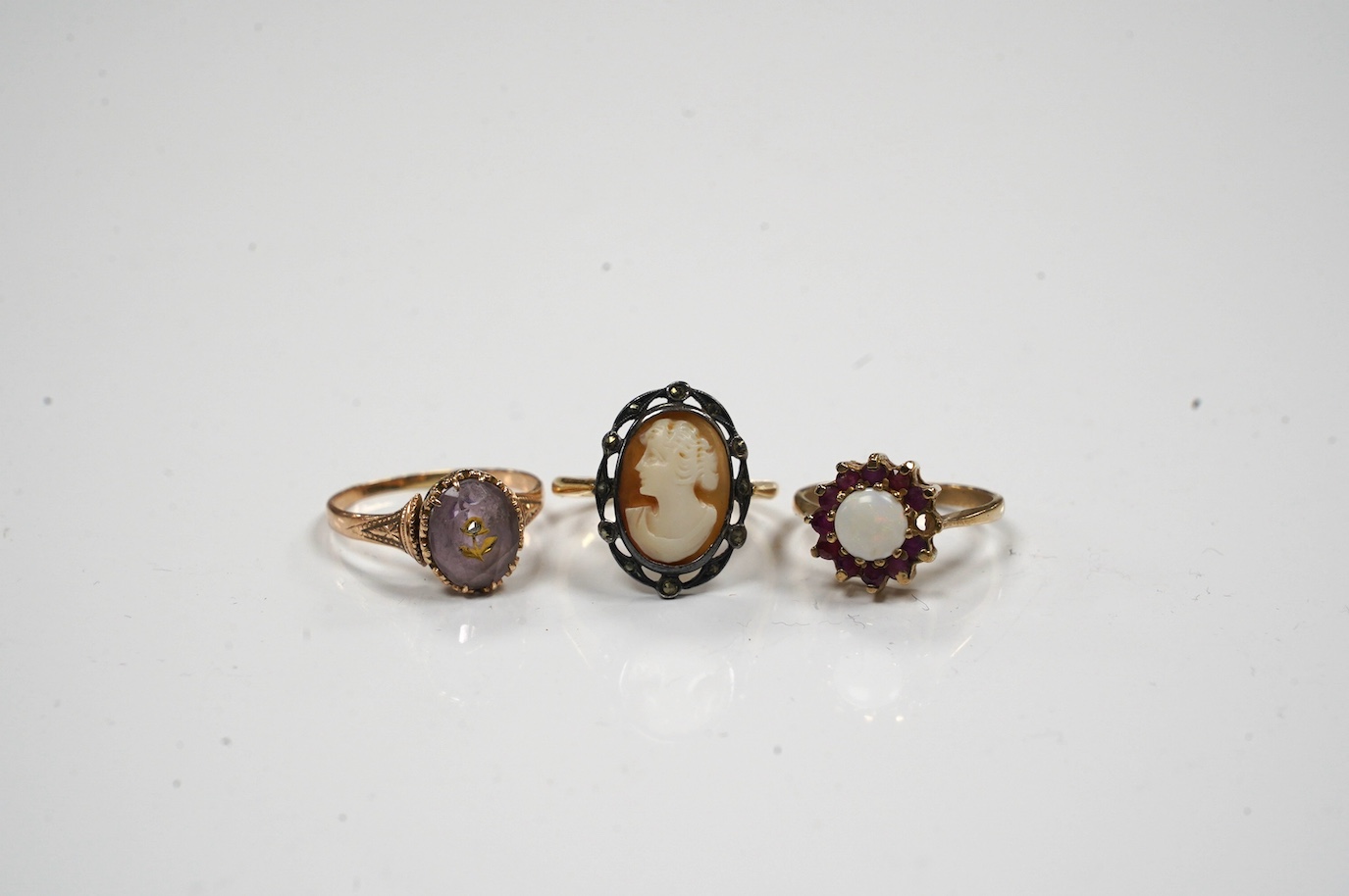 A late Victorian yellow metal amethyst and diamond chip set 'flower' ring, size P and two other rings. Condition - poor to fair